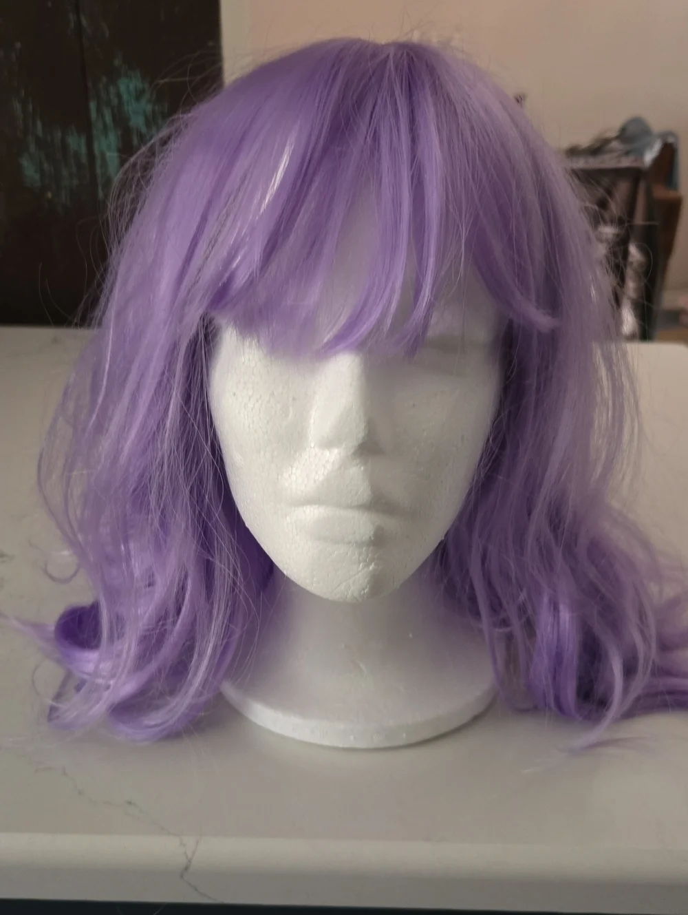 Lavender Wig, Wavy Style With Front Bangs. And Styrofoam Head.